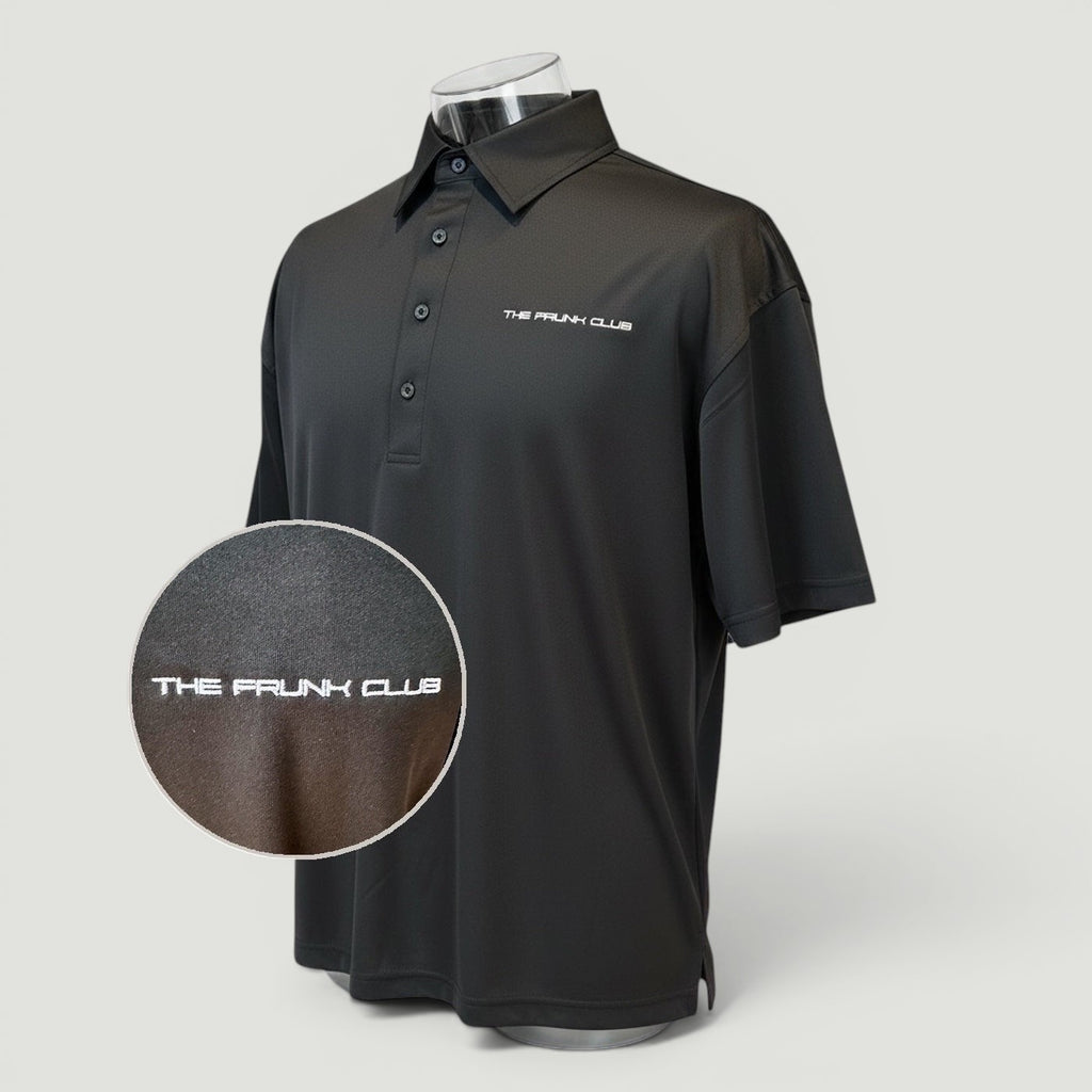 The Frunk Club black performance polo shirt with subtle branding, classic collar, and button placket. Lightweight, breathable fabric.