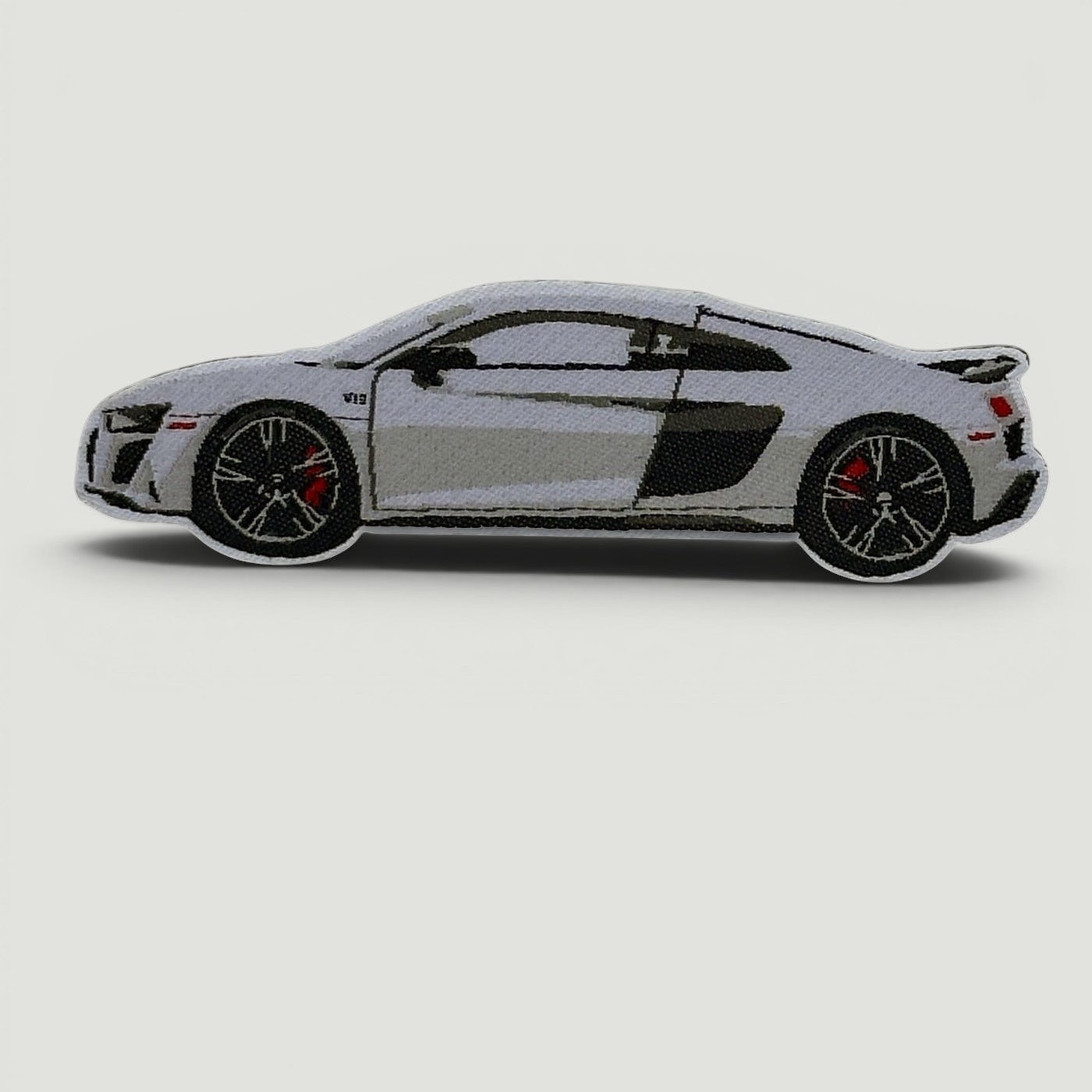 The Frunk Club white Audi R8 V10 embroidered patch with black accents and red brake calipers.
