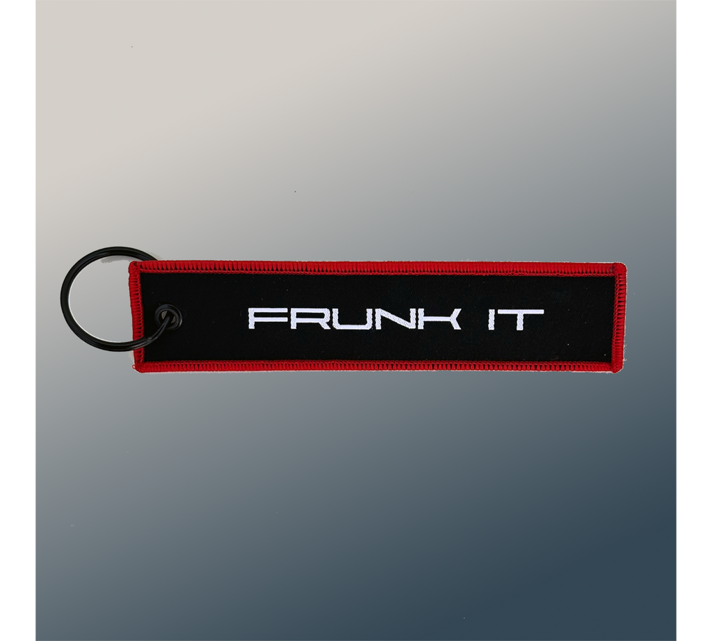The Frunk Club black embroidered key tag with red border and silver 'FRUNK IT' lettering.