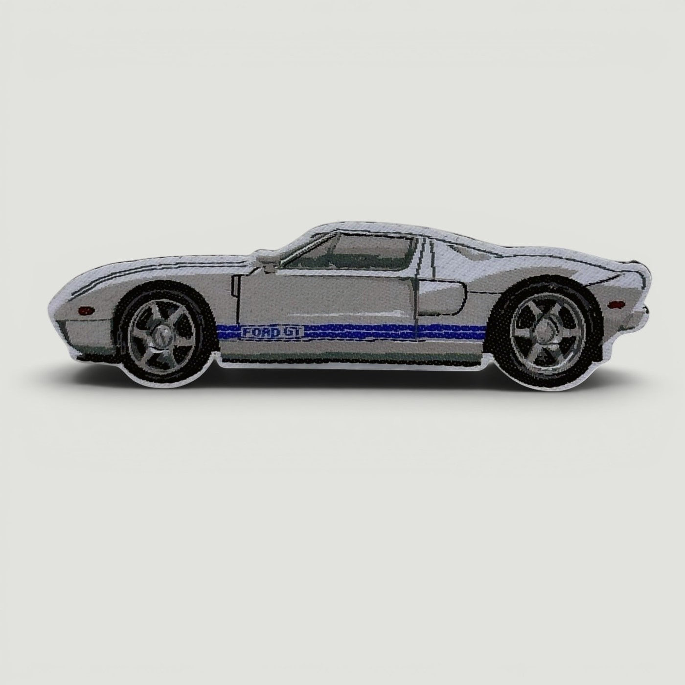 The Frunk Club white Ford GT embroidered patch with blue racing stripes.