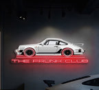 The Frunk Club 24" neon wall art sign featuring a white Lamborghini silhouette with red wheels and "THE FRUNK CLUB" text in red neon.