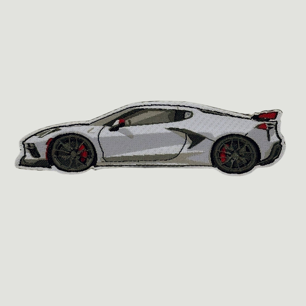 The Frunk Club white C8 Corvette embroidered patch with black wheels and red brake calipers.