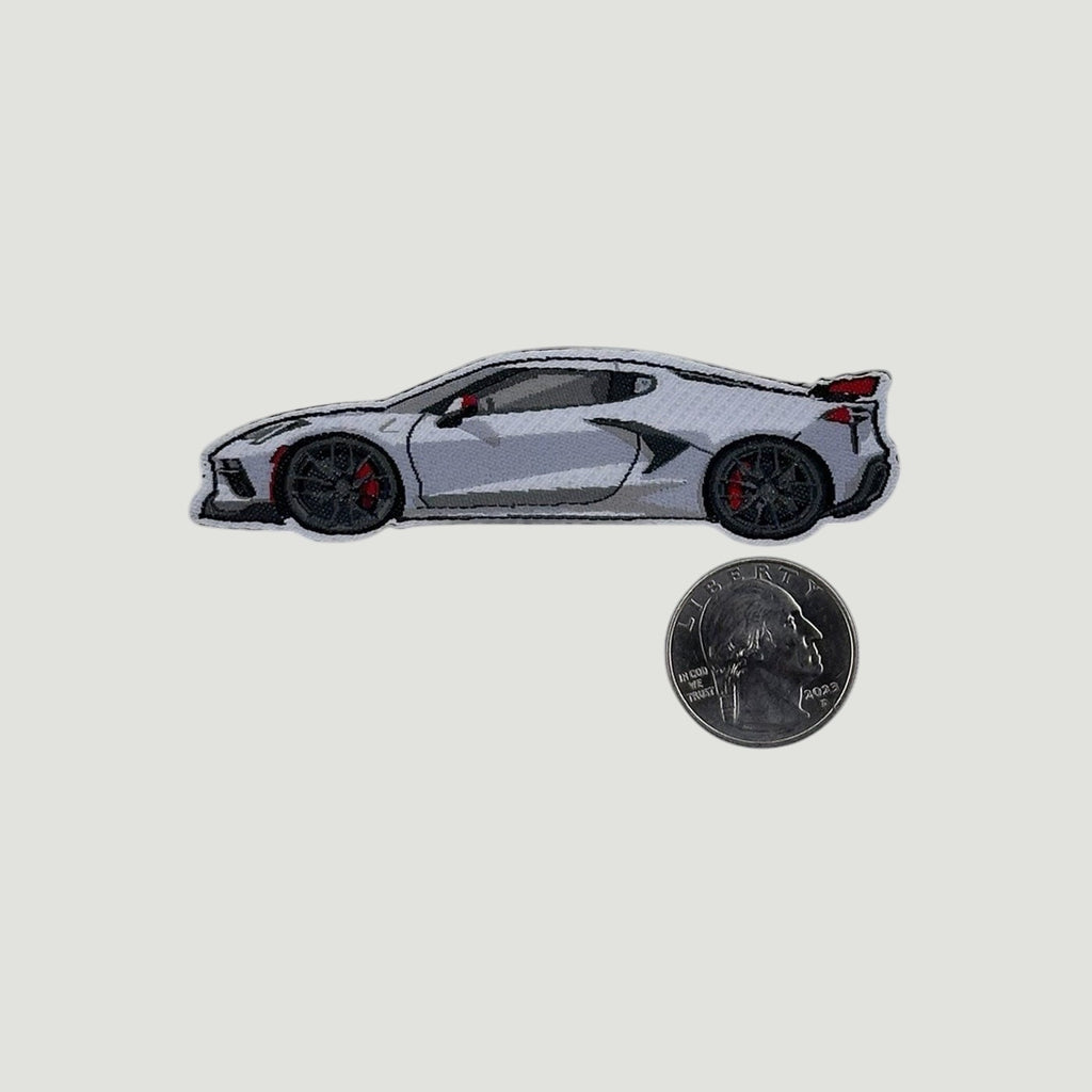 The Frunk Club woven patch featuring a white C8 Corvette with red accents and black wheels. 3.5" W x 1" H.