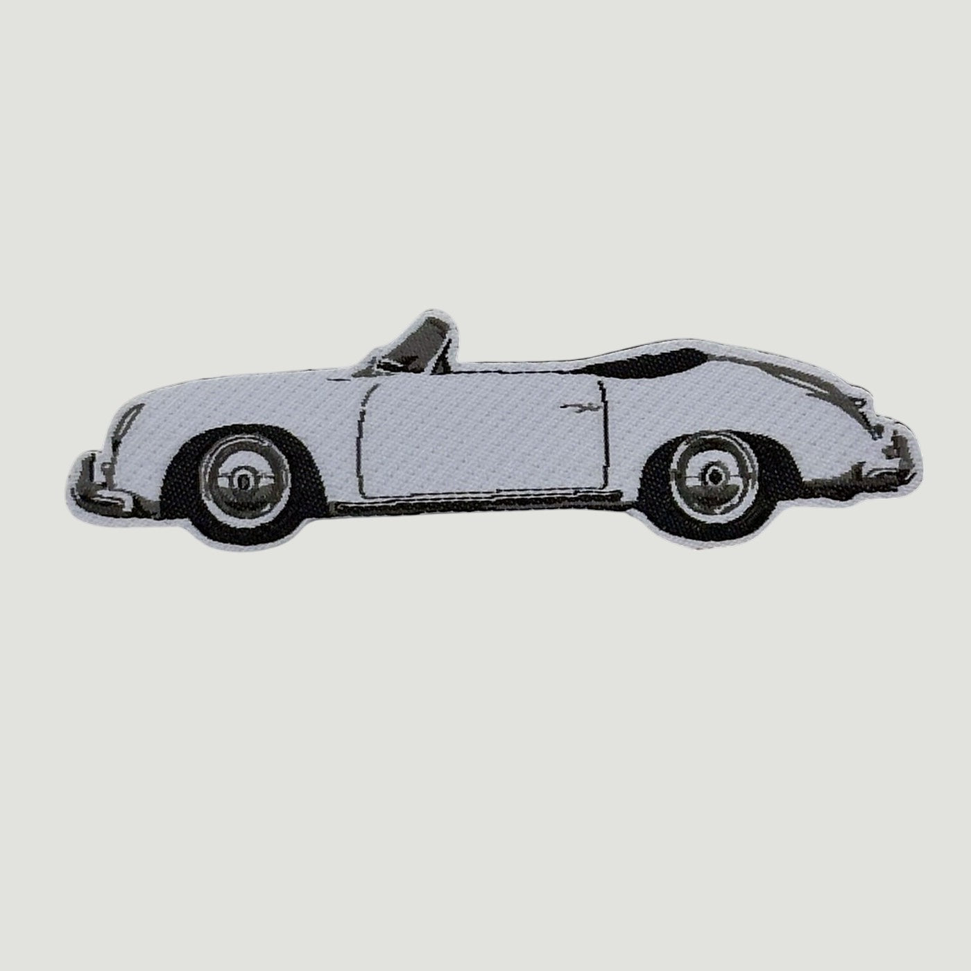 The Frunk Club woven patch featuring a white convertible car with black accents. Heat-transfer backing.