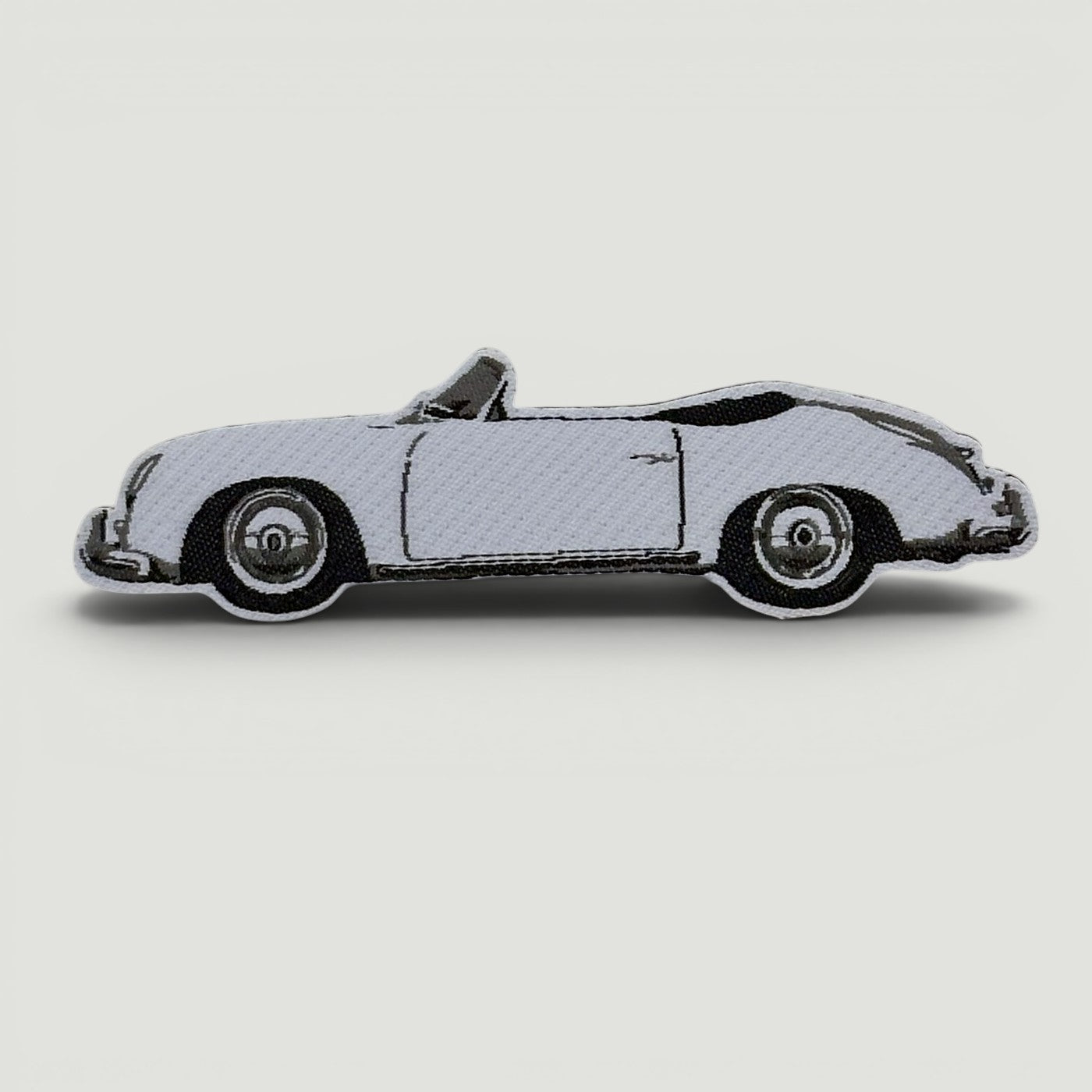 The Frunk Club embroidered patch of a white convertible Porsche 356 Speedster.