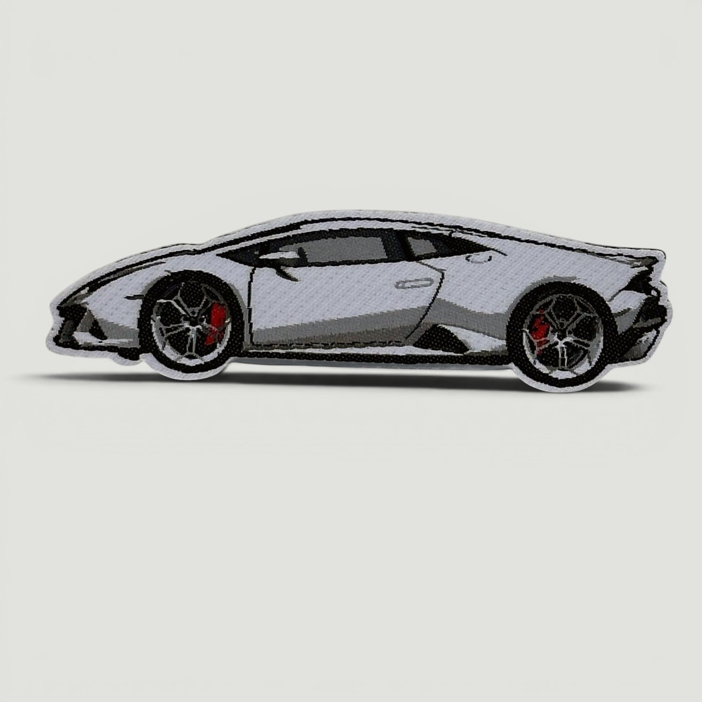 The Frunk Club Pit Lane Bundle custom woven patch featuring a white sports car with red brake calipers.